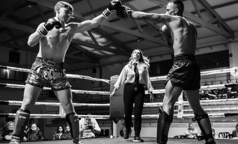 Combate de Muay Thai con árbitro en el centro del ring